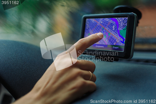 Image of woman looks at a GPS Navigator in the car