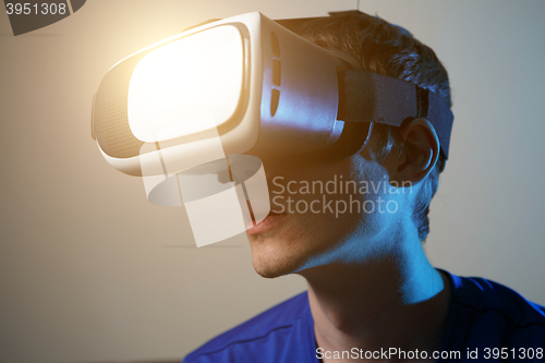 Image of Man wearing virtual reality goggles.