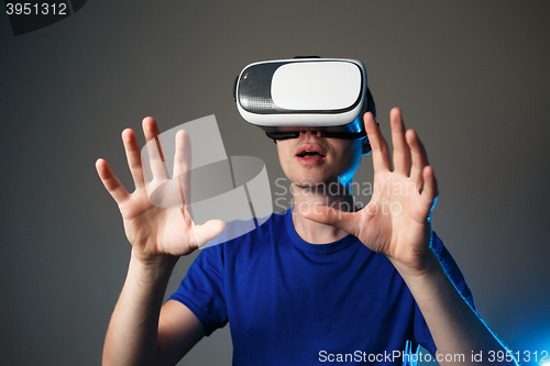 Image of Young man using a VR googles.