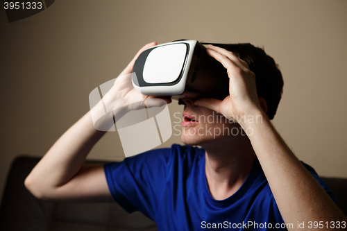 Image of Man wearing virtual reality goggles.