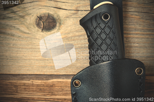 Image of part of hunting knife in a leather scabbard
