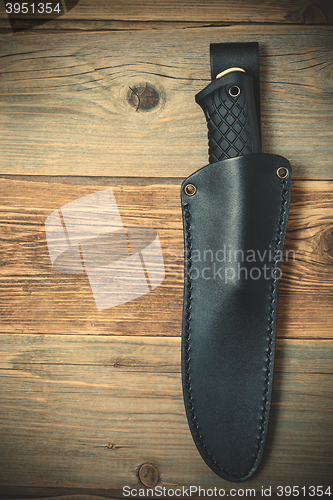 Image of hunting knife in a leather scabbard