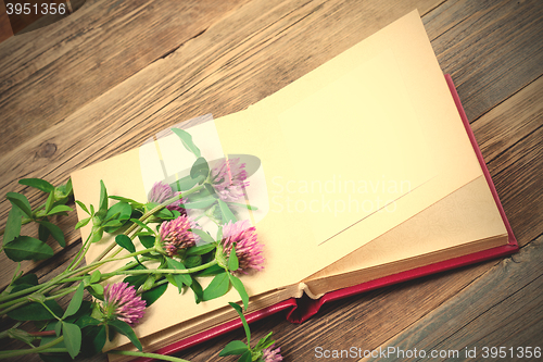 Image of album and clover flowers with copy space