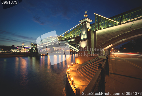 Image of Night landscape with the illuminated bridge and river. Moscow, R