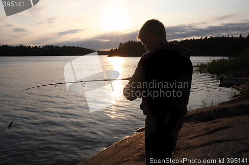 Image of  Boy Fishing at Sunrise