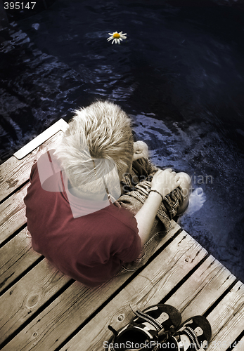 Image of Boy sitting on a Footbridge