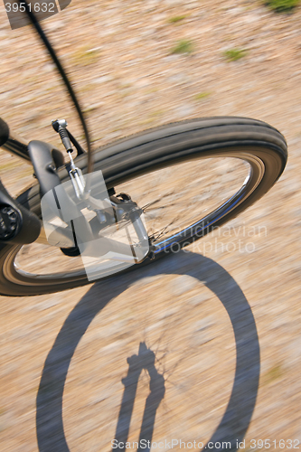 Image of Front wheel of a bike on a dirt road