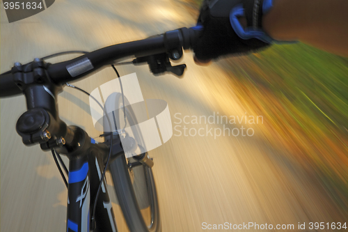 Image of Fast motion mountain bike on a road