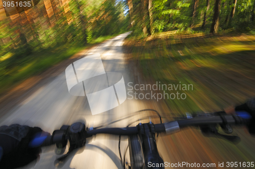 Image of Fast motion mountain bike on a road