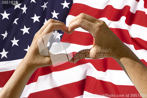 Image of Hands heart symbol, USA flag