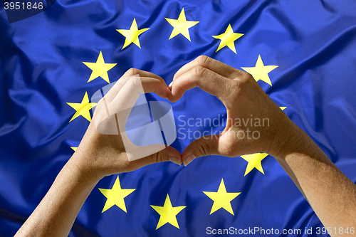 Image of Hands heart symbol, European Union flag