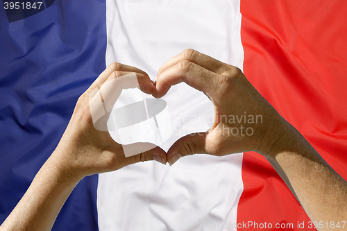 Image of Hands heart symbol, France flag