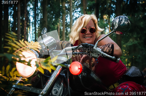 Image of Mature woman biker on a motorcycle