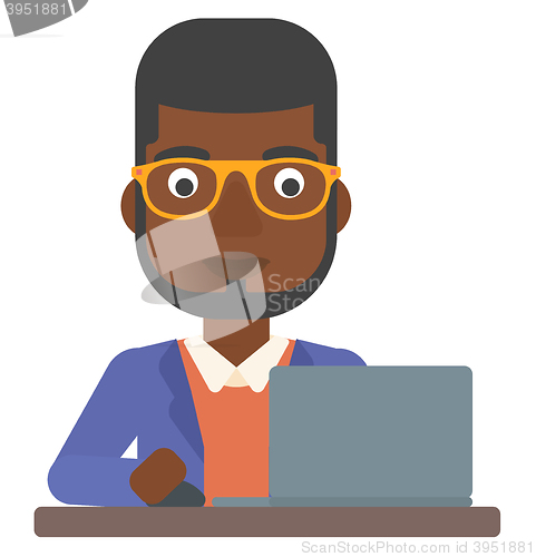 Image of Man working at laptop.