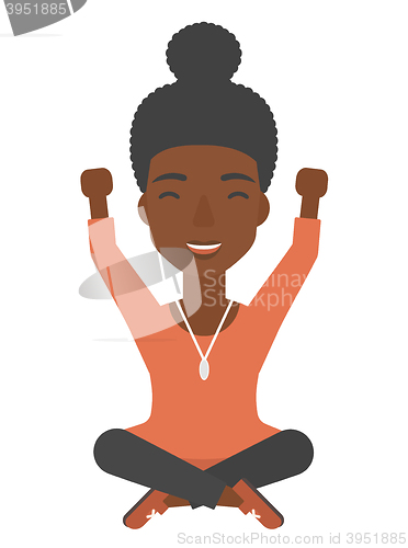 Image of Woman sitting with crossed legs and raised hands up.