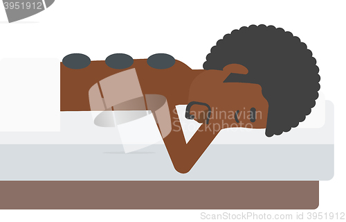 Image of Man getting stone therapy.