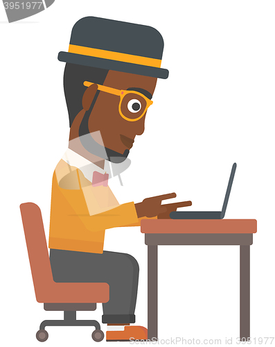 Image of Man working at laptop.