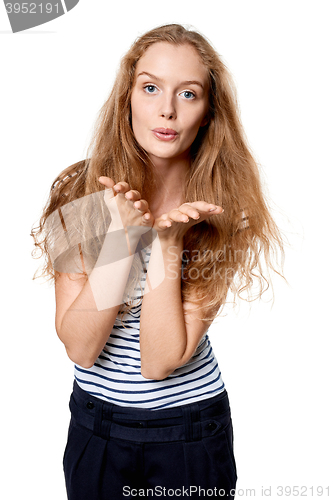 Image of Woman blowing a kiss at camera