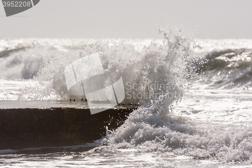 Image of Waves breaking on the concrete pier