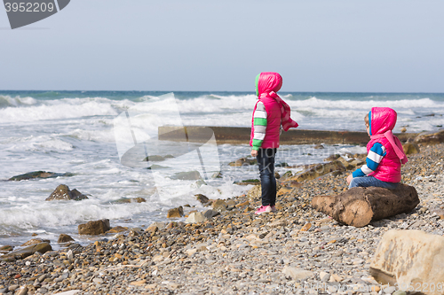 Image of Two girls on the beach looking into the distance