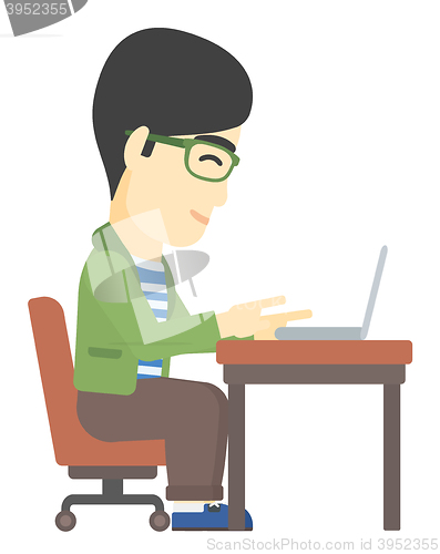 Image of Man working at laptop.