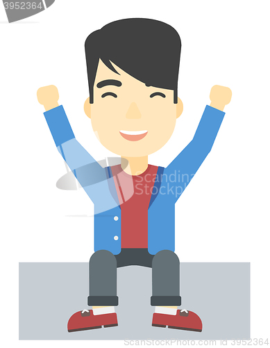 Image of Man sitting with raised hands up.