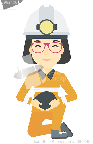 Image of Miner holding coal in hands.