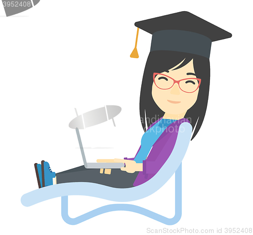 Image of Graduate lying in chaise lounge with laptop.