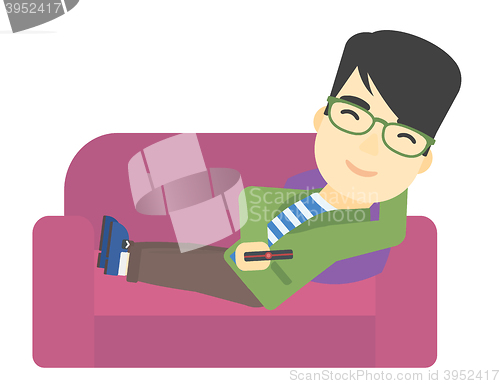 Image of Man sitting on the couch with remote control.