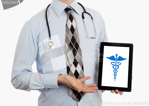 Image of Doctor holding tablet - Caduceus symbol