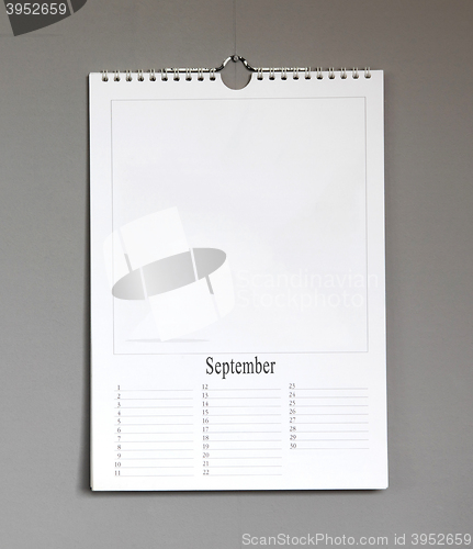 Image of Simple old birthday calendar hanging on a grey wall - September