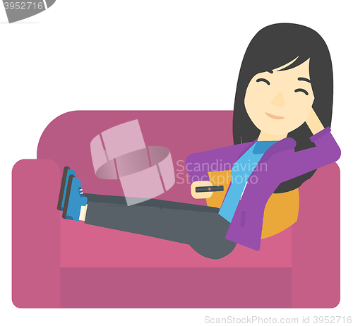 Image of Woman sitting on the couch with remote control.