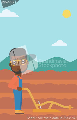 Image of Farmer on the field with plough.