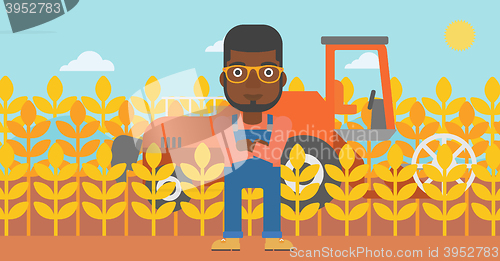 Image of Man standing with combine on background.