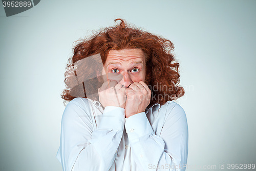 Image of The young frightened man looking at camera