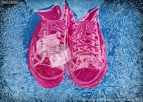 Image of Blue background with feet in pink bright sneakers 
