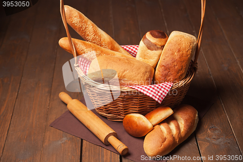 Image of Arrangement of bread in basket and rolling pin 