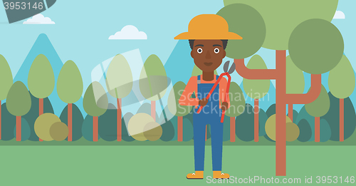 Image of Farmer with pruner in garden.