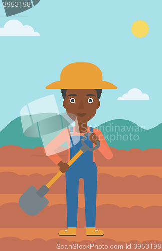 Image of Farmer on the field with shovel.