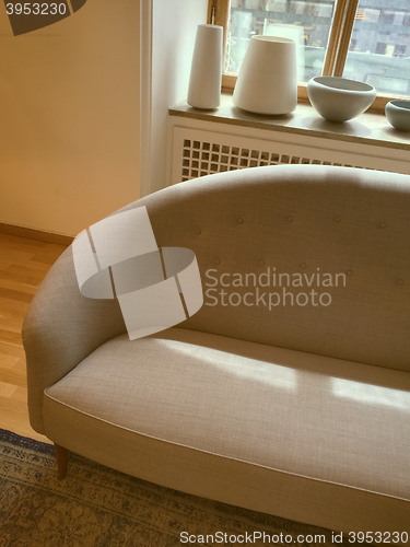 Image of Elegant sofa in a room decorated with ceramic artwork