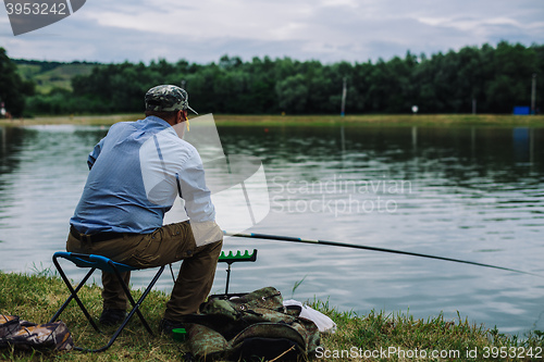 Image of Man catches fish with a fishing rod