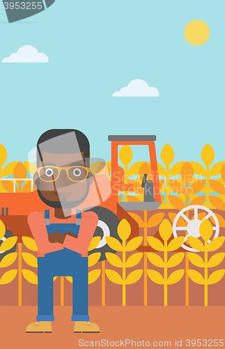 Image of Man standing with combine on background.