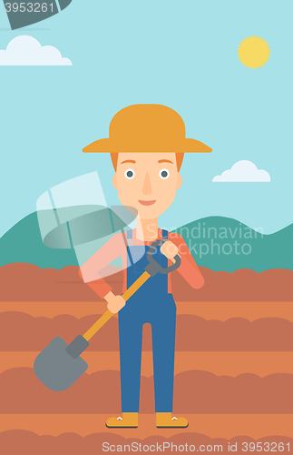 Image of Farmer on the field with shovel.