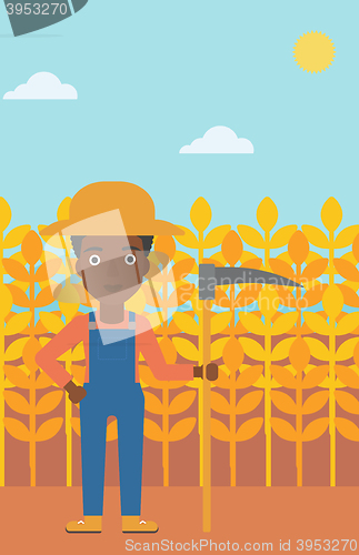 Image of Farmer on the field with scythe.