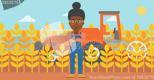 Image of Woman standing with combine on background.
