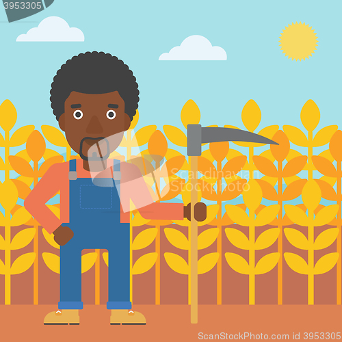 Image of Farmer on the field with scythe.