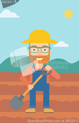 Image of Farmer on the field with shovel.