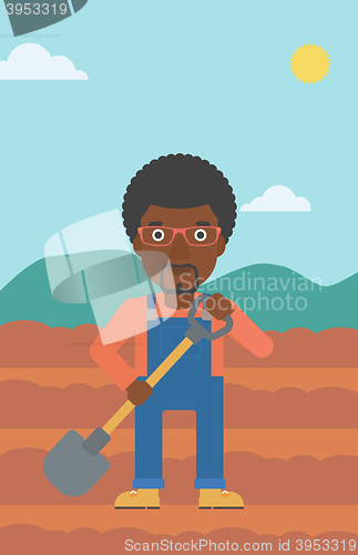 Image of Farmer on the field with shovel.