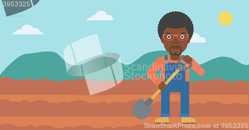 Image of Farmer on the field with shovel.