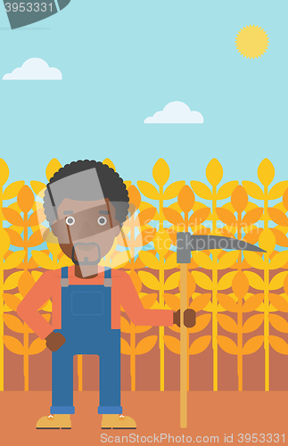 Image of Farmer on the field with scythe.